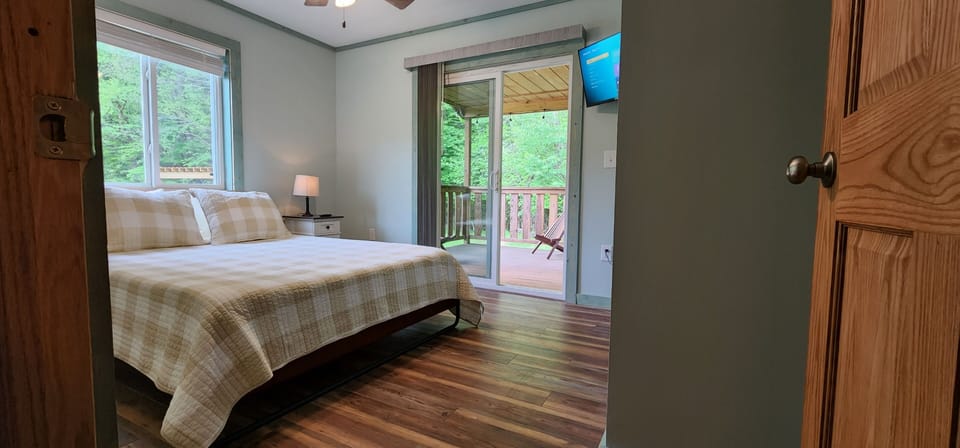 Rear bedroom opens onto back porch overlooking the river.