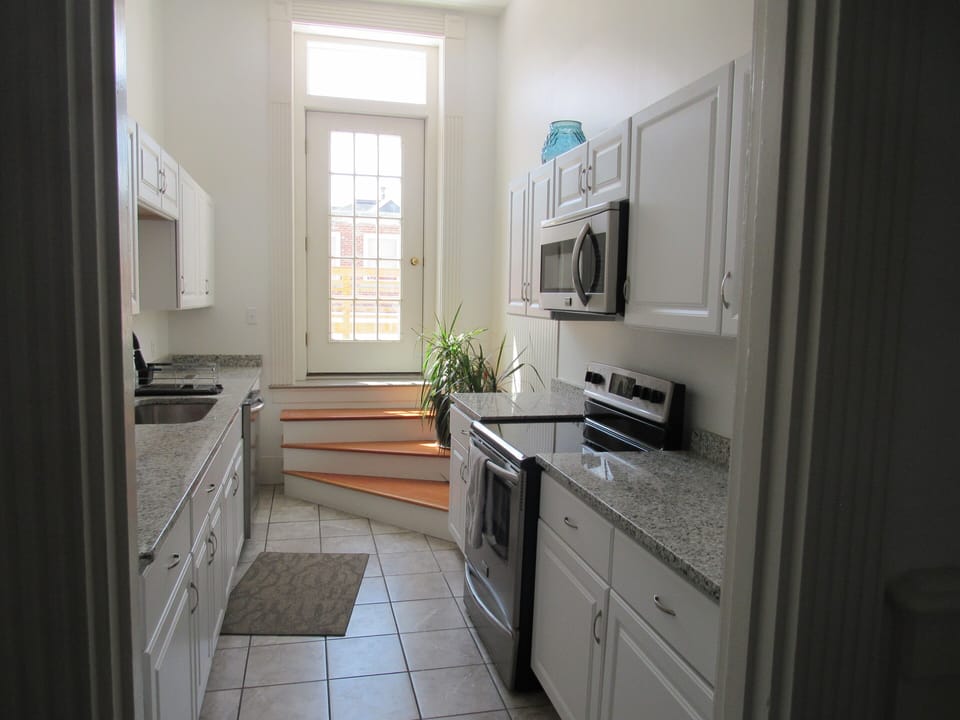 efficient Gally kitchen with plenty of new granite counter tops