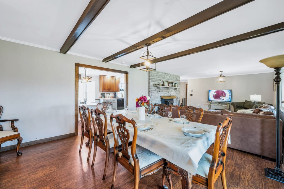 Dining table. Opening leads to kitchen area with a second table for dining