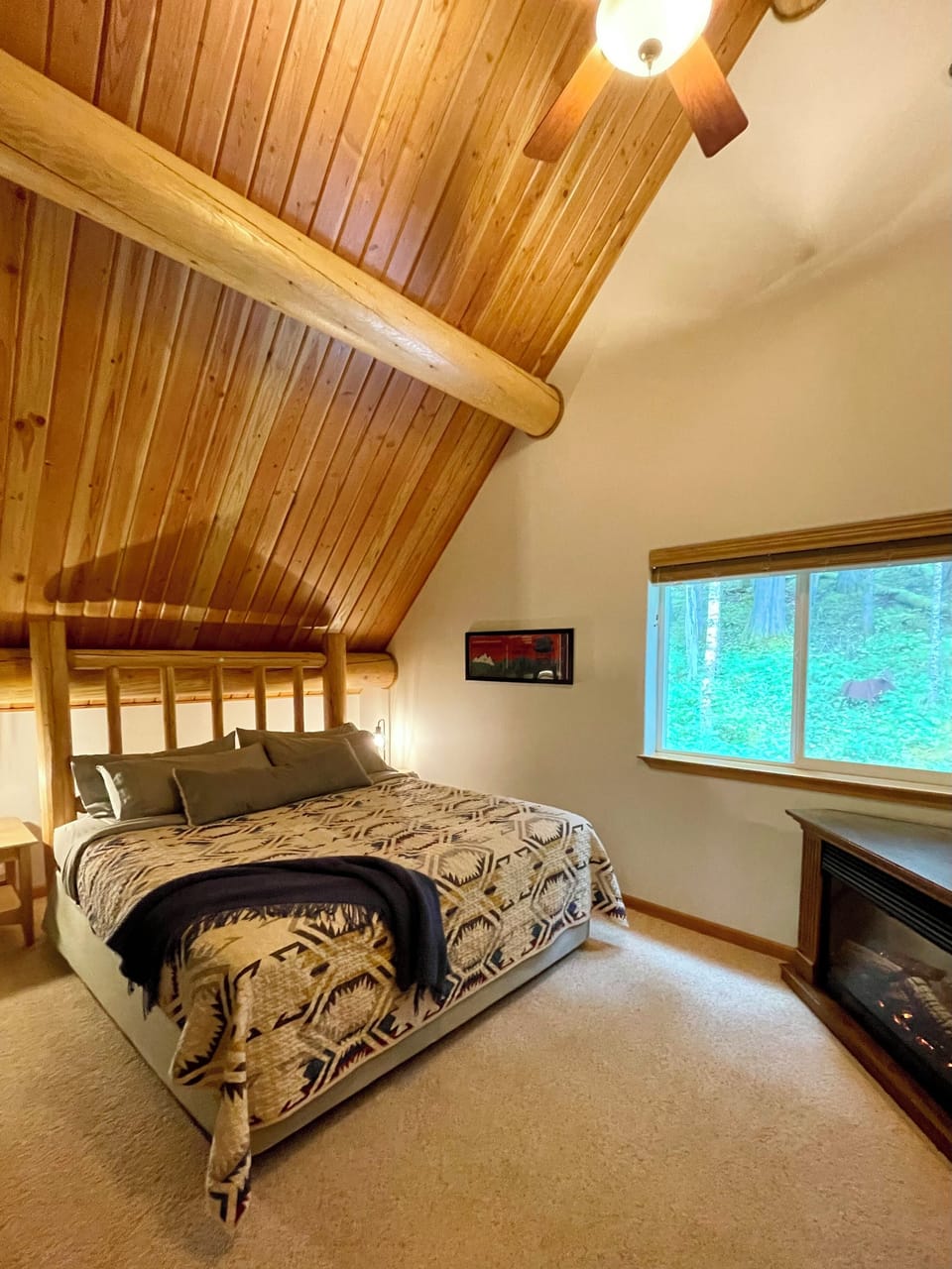 Upstairs primary suite has King bed, private 3/4 bath, walk in closet, & fan. 