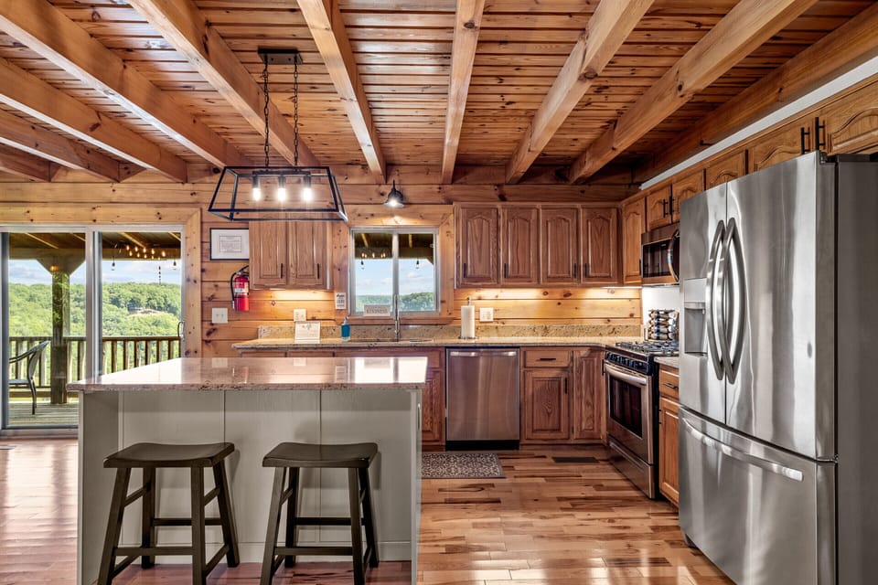 New SS appliances & a gas range. A slider out to the deck with a dining table.