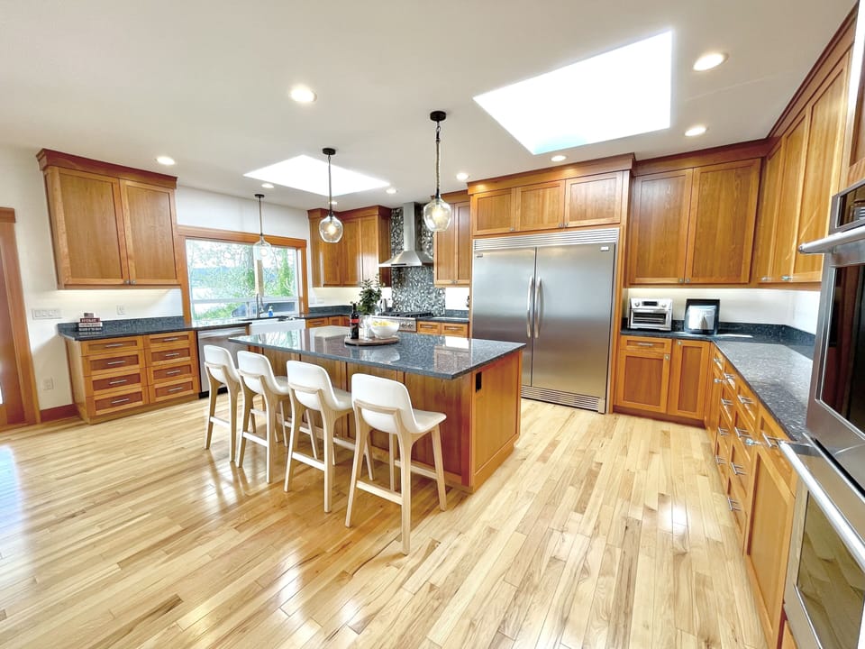 Large kitchen with oversized standing fridge and freezer. 