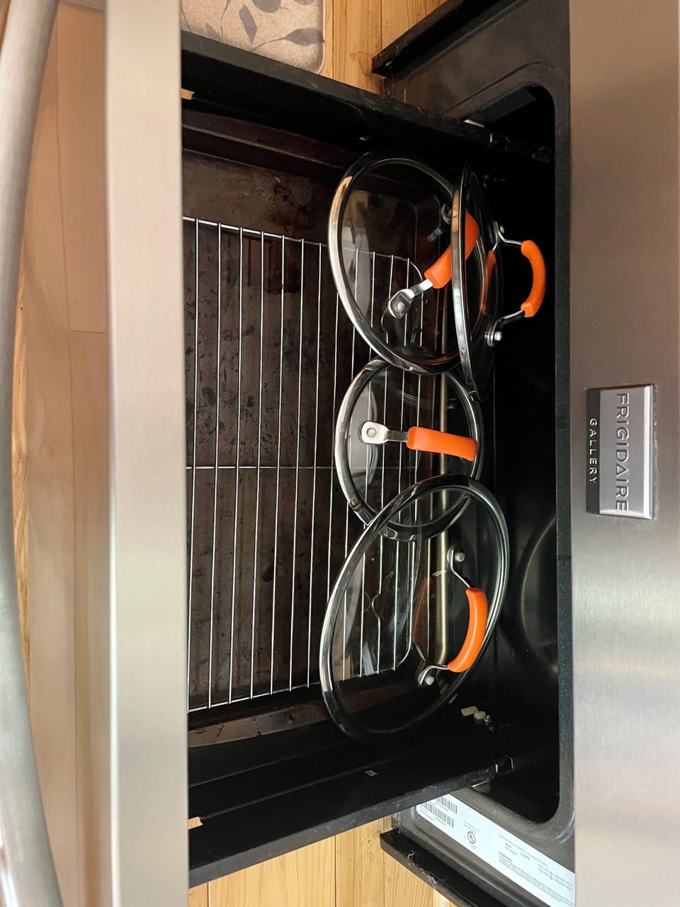 2 baking sheets, a cooling rack, and lids for each pot in the stove drawer.
