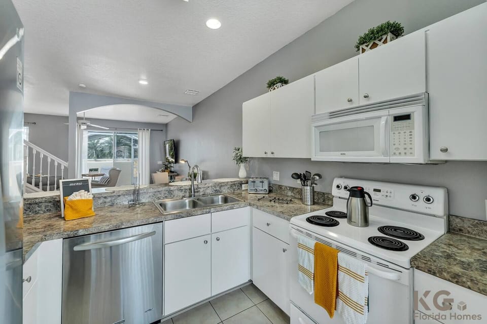 Semi-open kitchen with oven and microwave. 