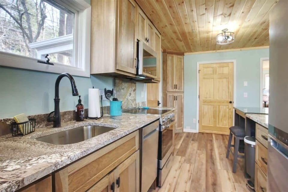 The kitchen has granite countertops, all new stainless appliances, and gorgeous cabinetry.