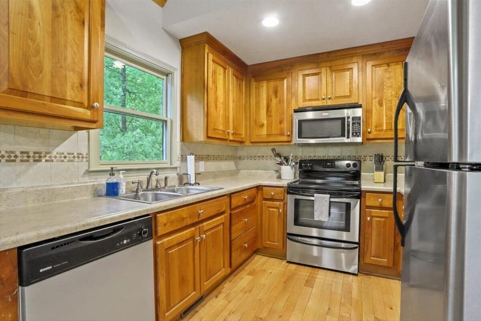 Fully stocked kitchen with electric range and dishwasher