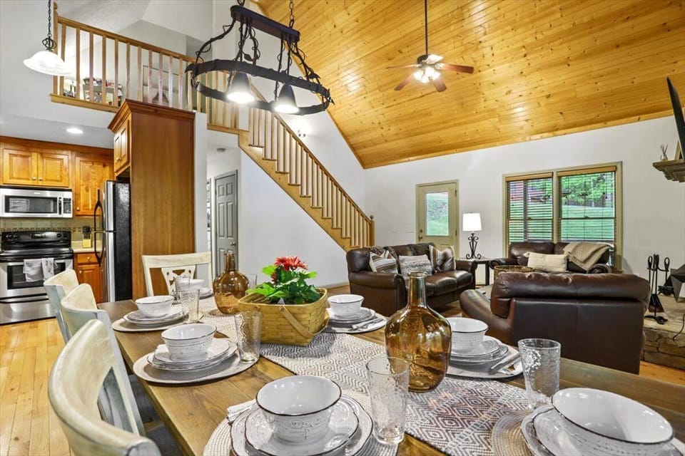 vaulted great room with wood ceilings and dining, seating for 8