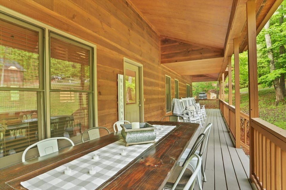 wide front porch with outside dining for 8, and 4 rocking chairs 