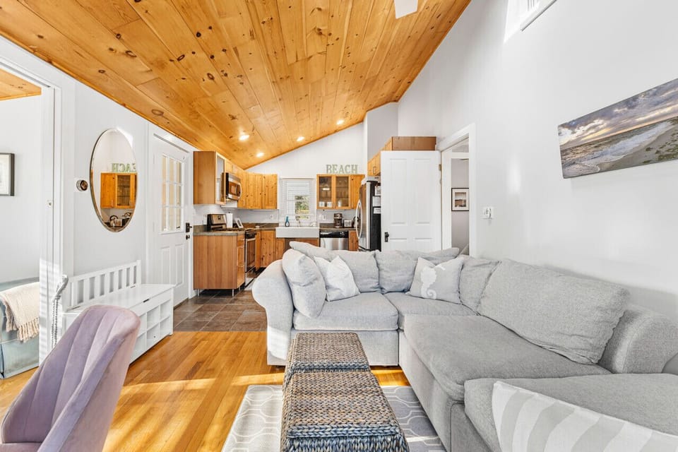 Open floor plan featuring distinct areas for dining space, modern kitchen, and inviting living room.