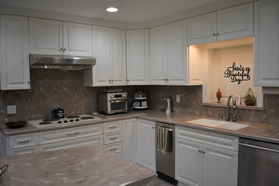 Kitchen has electric stovetop, oven, microwave, air fryer/toaster combo & more