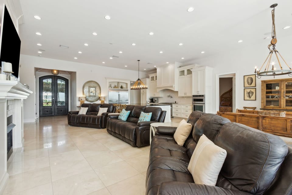 Great Room with Ample Seating, Flat Screen TV, Gas Log Fireplace, and Wall to Wall Doors with Oceanfront Views