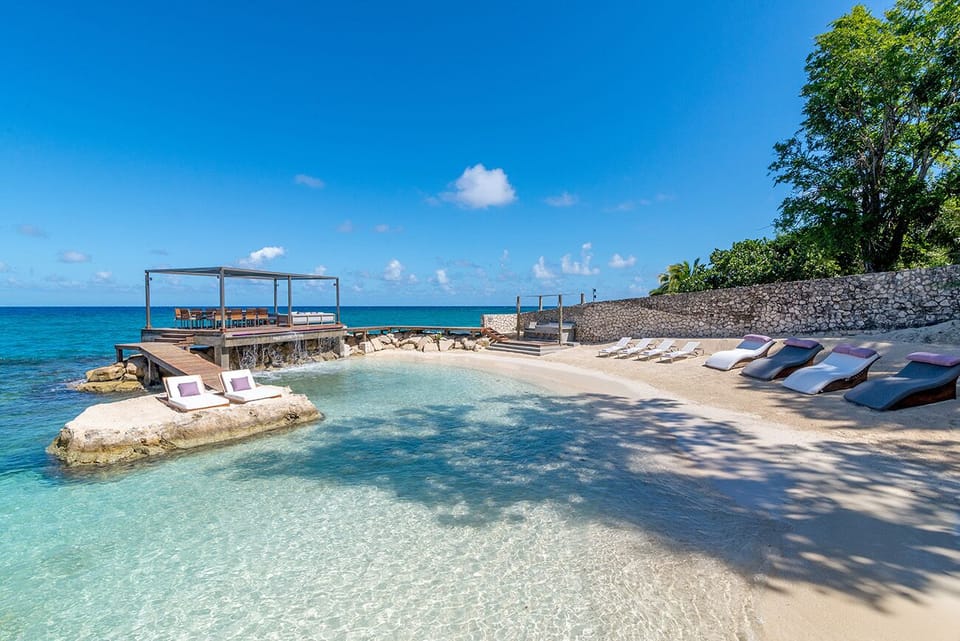 Bask in bliss: Sunbeds await at Promiseas Villa's private beach cove.