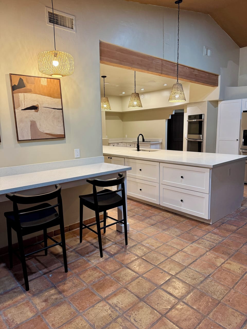 Island with eating counter and barstools