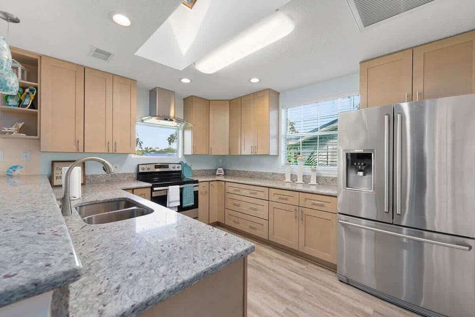Stocked kitchen with stowed away Keurig, microwave and French door refrigerator