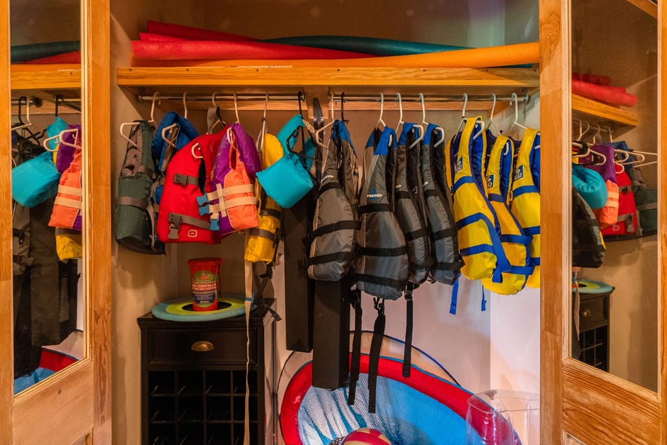 The closet at the base of the stairs contains life jackets for all ages.