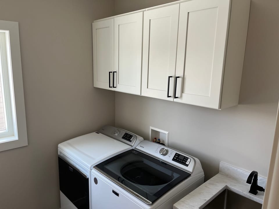 Large capacity washer and dryer and utility sink. 