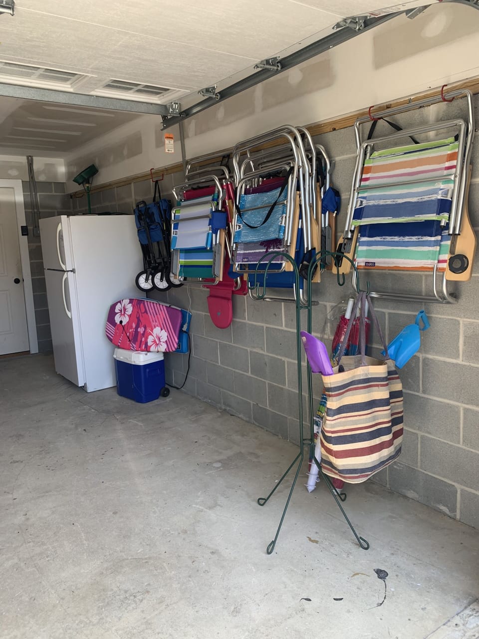 Garage beach toys chairs boogie boards extra fridge 