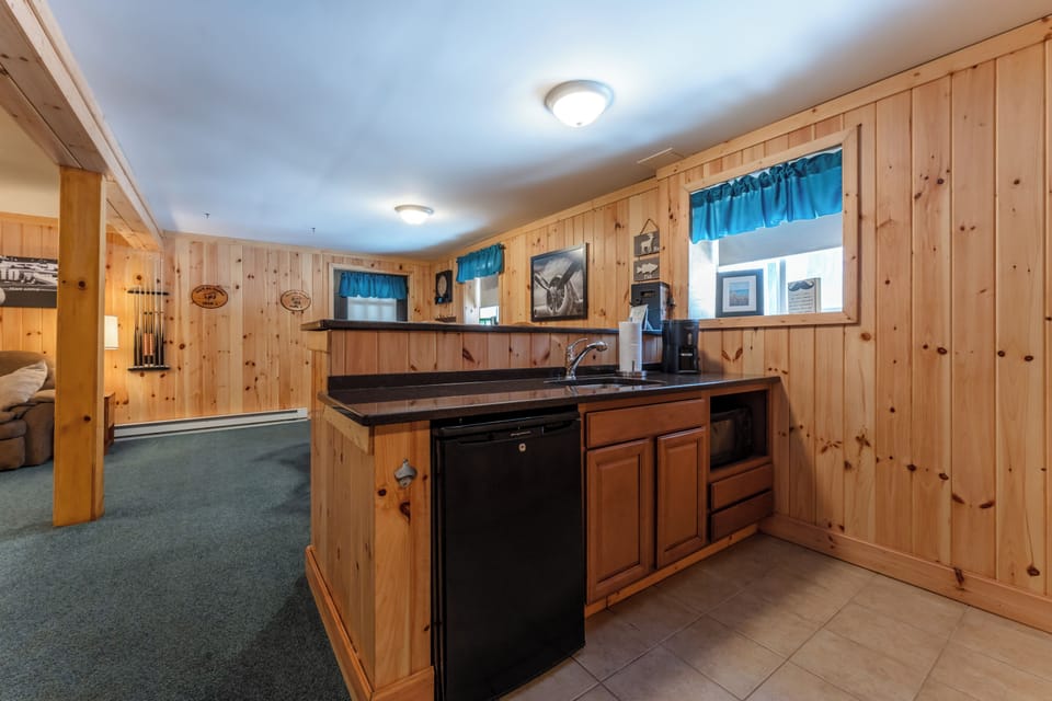 Wet bar with full sink, mini fridge, microwave and coffee.  Great for game night