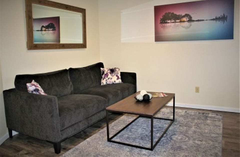 Embrace the perfect balance of comfort and sophistication as you unwind in this inviting living room in our short-term rental. The cozy ambiance, modern furnishings, and tasteful decor create an atmosphere that exudes both warmth and elegance. Whether you