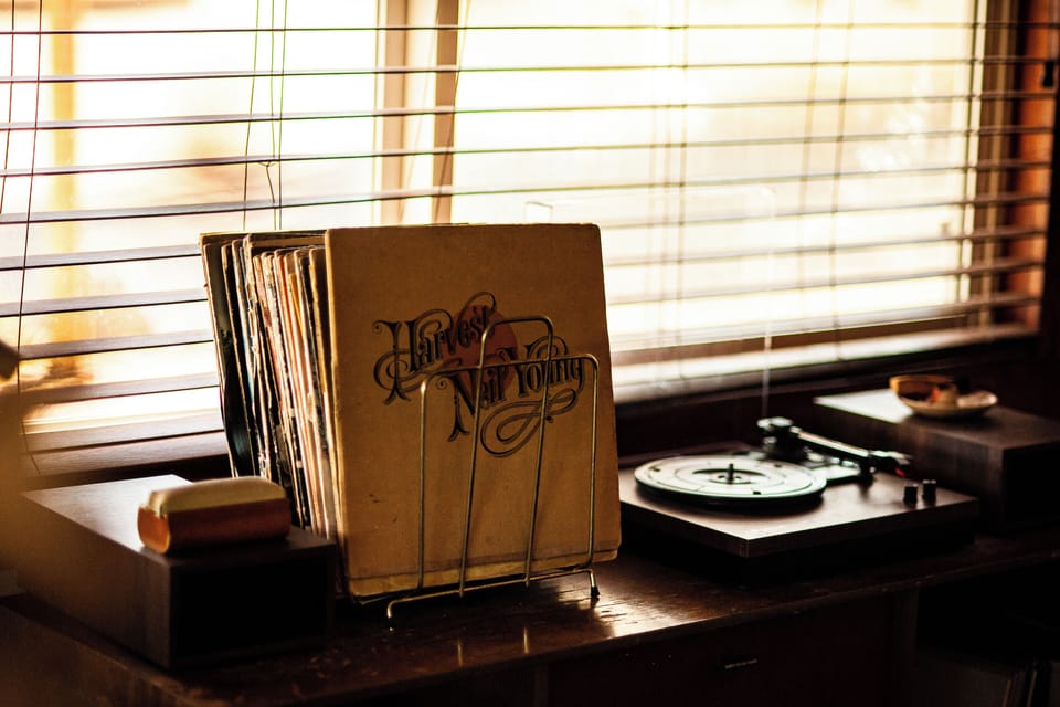 A charming vinyl collection and record player create a nostalgic ambiance for music lovers.