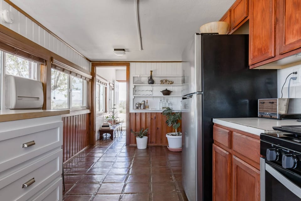 Bright and open kitchen featuring natural light and rustic charm.