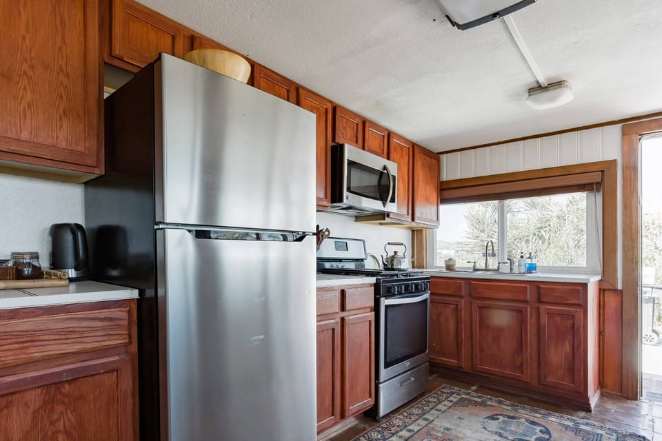 Fully equipped kitchen featuring modern appliances and warm wooden tones.