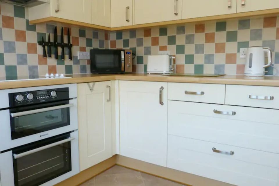 Well equipped family kitchen including double oven with grill and microwave