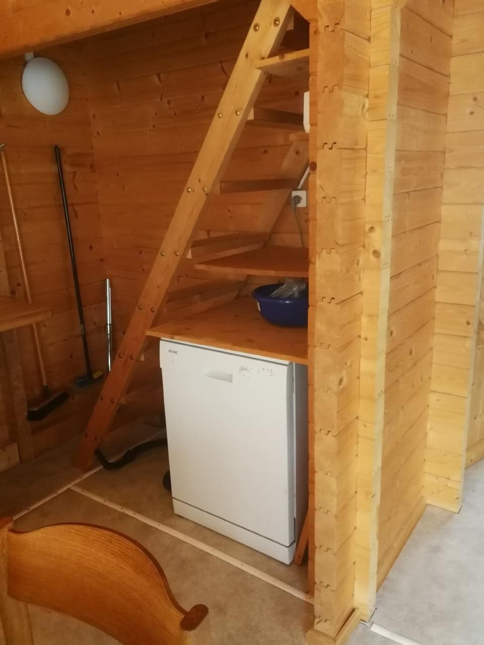 Dishwasher and stairway to the upper room
