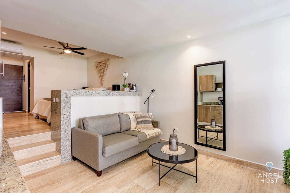 The sunken living room provides space between the bed & living/kitchen area