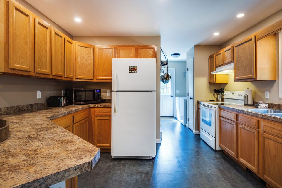Large kitchen includes: toaster, microwave, electric range, coffee pot, pots, pans and outdoor bbq! 