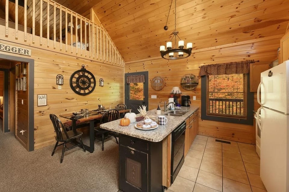 Rustic kitchen and dining area with vaulted ceilings and autumn views.