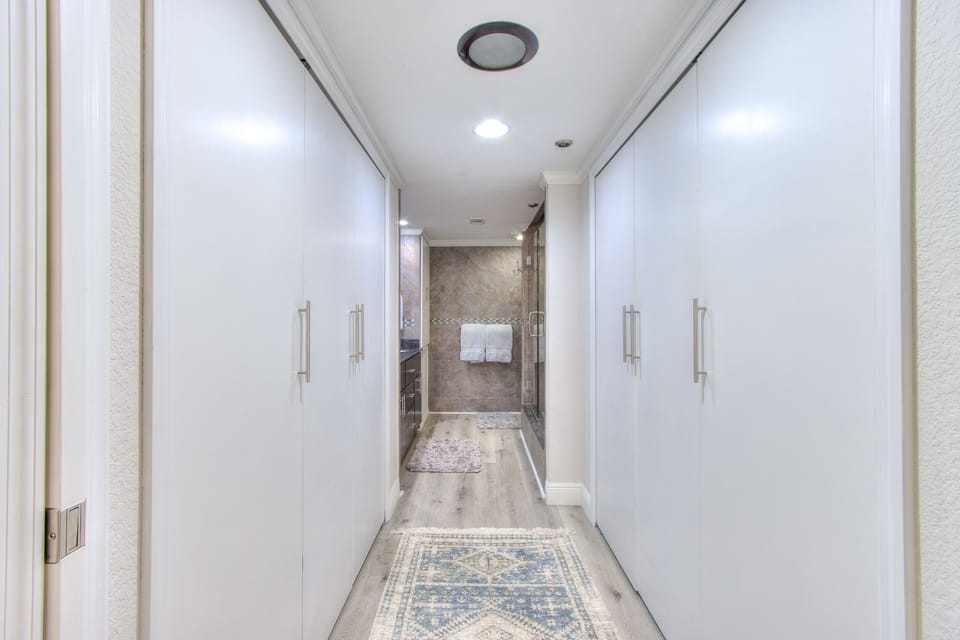 Theirs & Theirs closets leading to the bathroom.