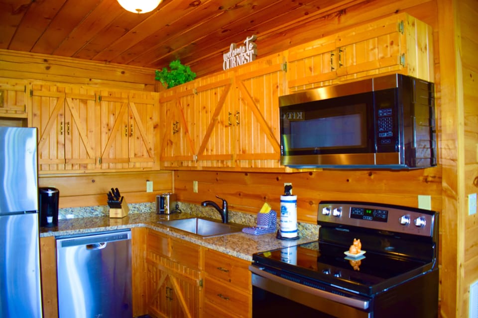 Kitchen with stainless appliances and granite countertop.