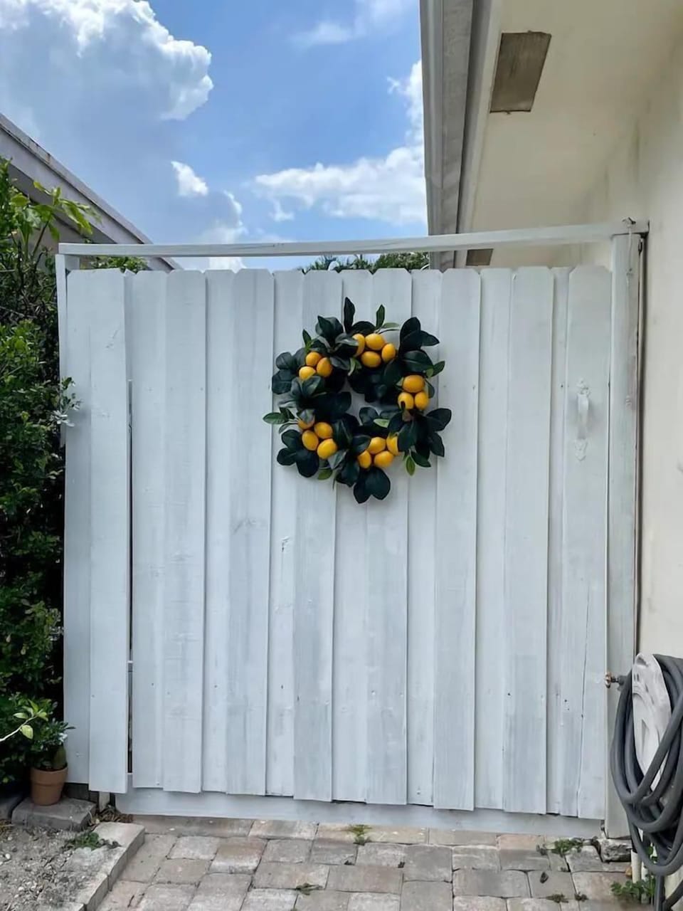 the suite is located on the left side when facing the property behind the white fence.

The suite does not share any spaces with the main side of the home other than the driveway 