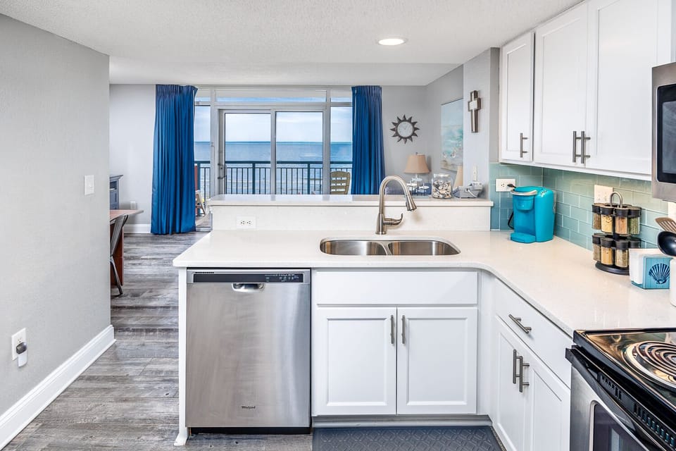 Full size kitchen with "Whirlpool" stainless steel appliances