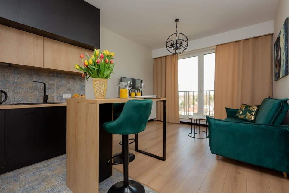 A stylish living space featuring modern furniture, wooden flooring, and decorative artwork for a cozy atmosphere.