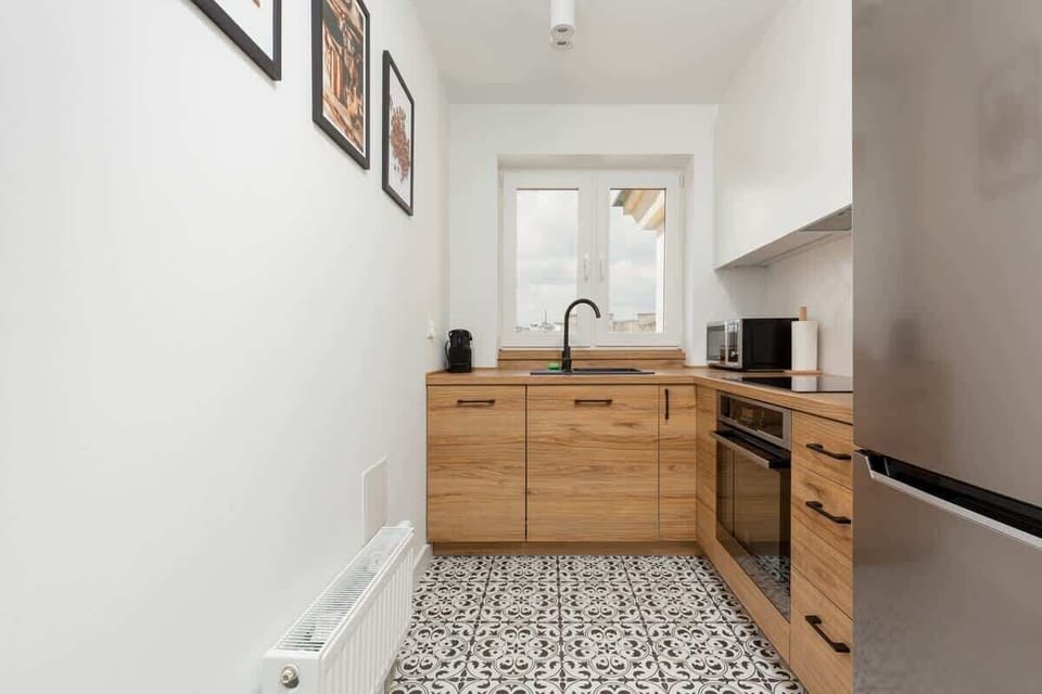 The kitchen's contemporary decor complements the apartment's style.