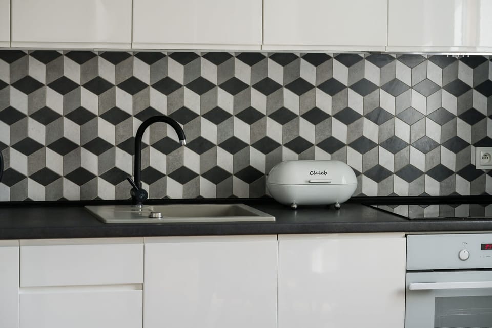 The sleek design of the kitchenette blending seamlessly with the living area.