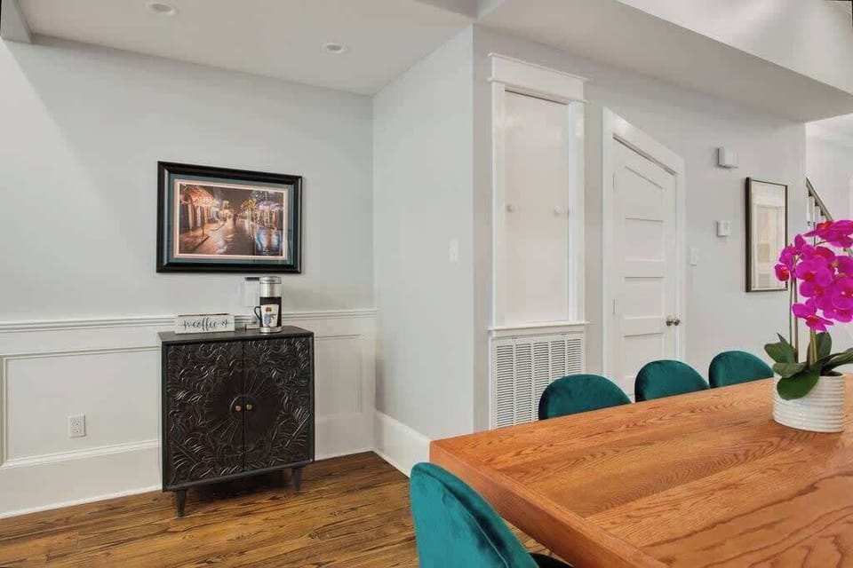 Dining area with thoughtful details and local-inspired artwork. Warm wood tones and comfortable seating create a welcoming spot to start your morning or unwind with a drink.