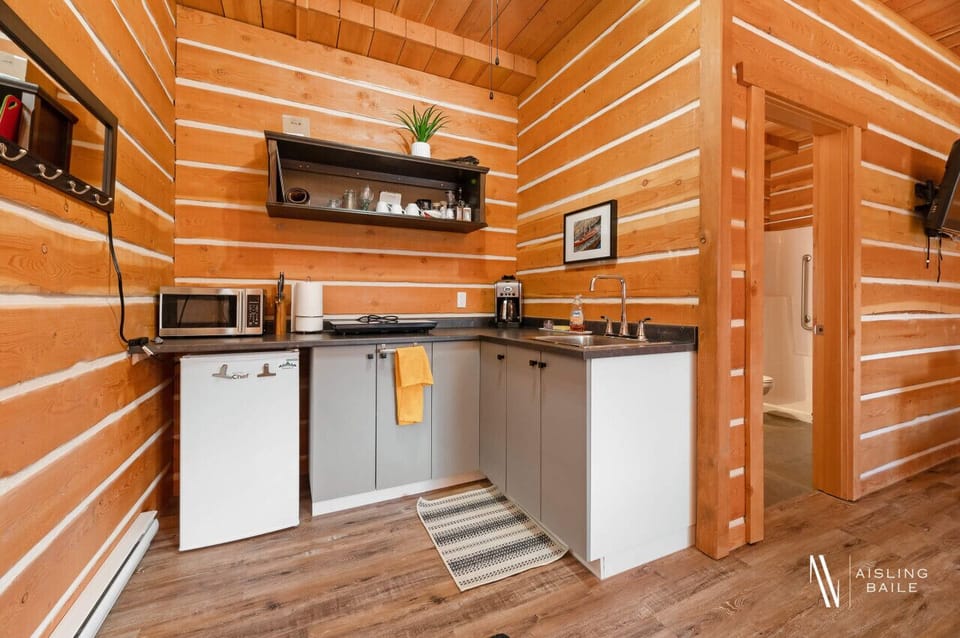 The kitchenette features a drip coffee maker, microwave, hot plate, and a toaster.