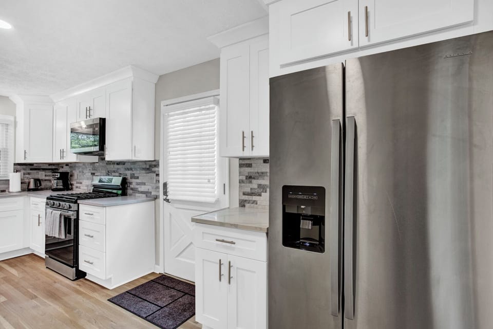 Open new kitchen with stainless steel appliances, kitchen island -MainLevel