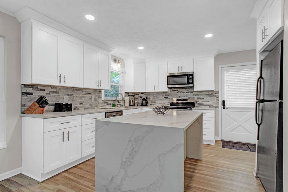 Open new kitchen with stainless steel appliances, kitchen island -MainLevel
