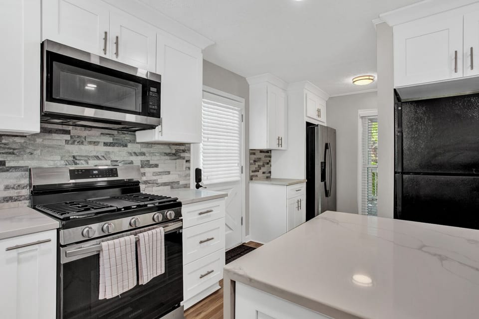 Open new kitchen with stainless steel appliances, kitchen island -MainLevel