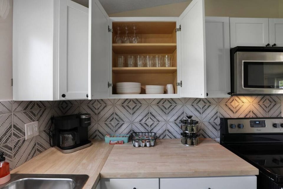 Kitchen (cabinets, microwave, sink, and stove)