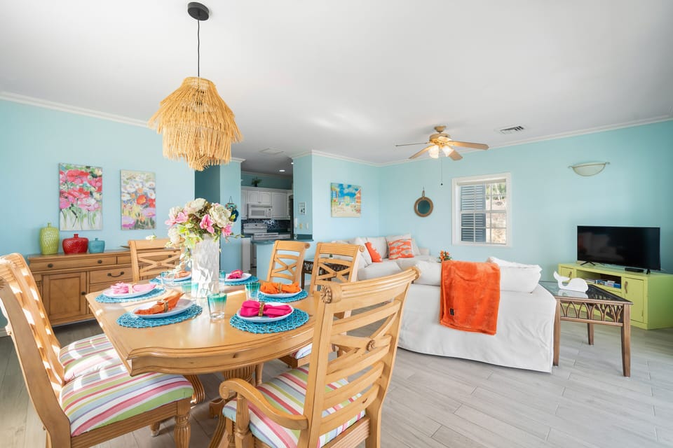 The colorful dining room offers a true  island vibe with seating for 6. 