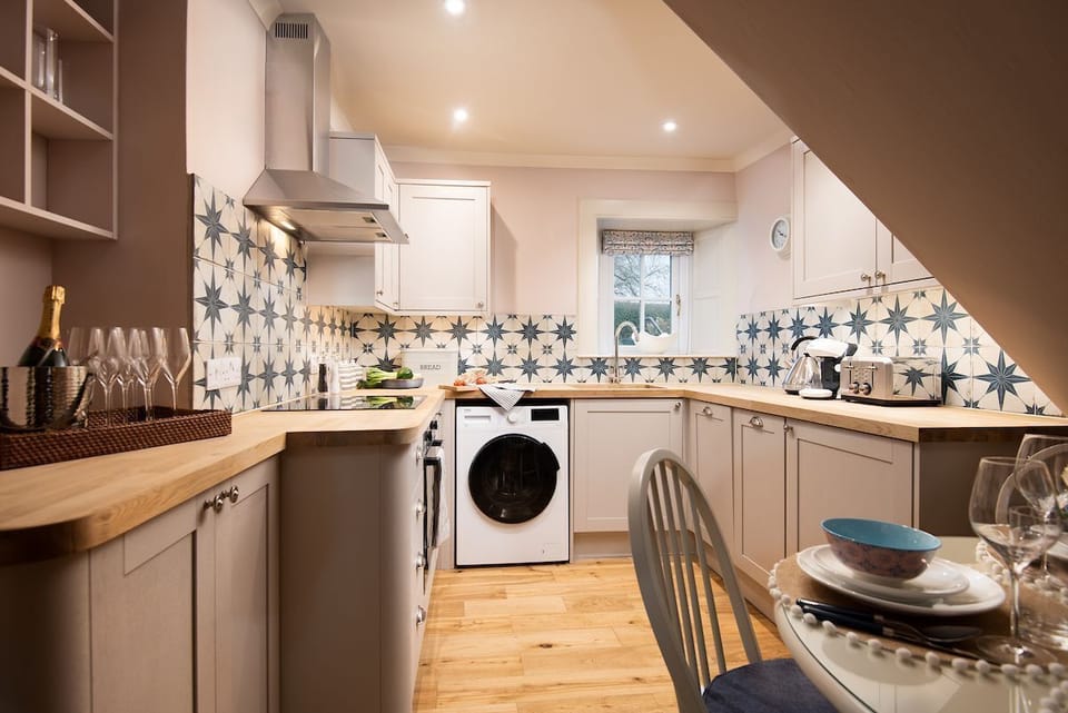 Bughtrig Cottage - a well-equipped Shaker-style kitchen providing all the essentials for a self-catered holiday