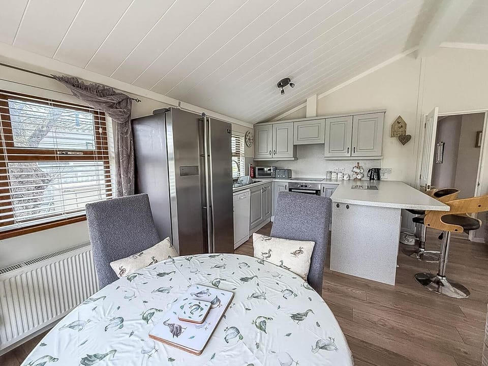 Situated conveniently opposite the kitchen, this dining booth is the ideal spot for sharing meals, playing board games, or simply planning your next day's adventure in the coastal county of Suffolk.
