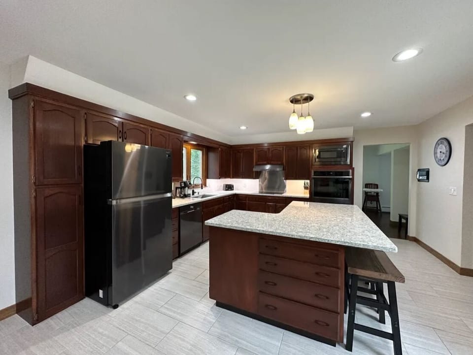 Kitchen, fully stocked with cook and serving ware, place settings for 20. 