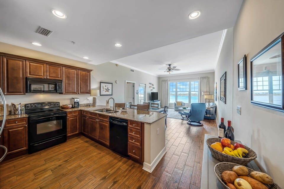Open concept kitchen/living area, featuring granite counter tops and updated flooring.