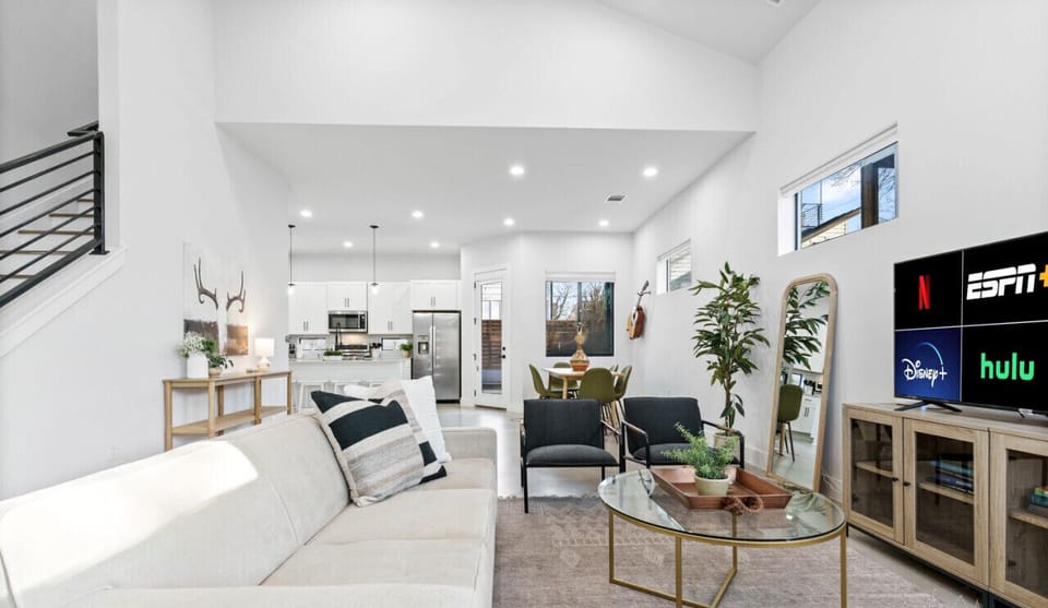 Living room with plenty of seating options, natural light, smart tv, and sleeper sofa